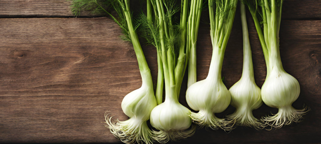 A bunch of fennel on a wooden table.